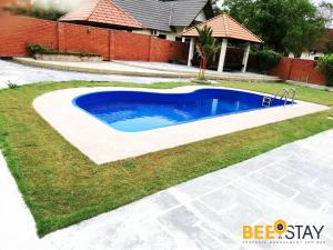 a swimming pool in a yard next to a house at Melaka Afamosa DAmour Villa 12PAX with Private Pool & BBQ in Kampong Alor Gajah
