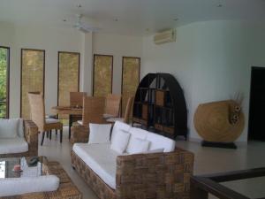 a living room with a couch and a table at Sunrise Villas Koh Samui- enjoy your Holiday in Thong Son Beach +8 photos