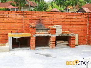 a brick wall with a bench in front of it at Melaka Afamosa DAmour Villa 12PAX with Private Pool & BBQ in Kampong Alor Gajah