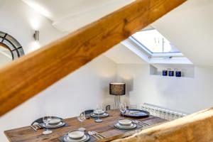 a dining table in a loft conversion with a skylight at The Old Warehouse Ely "Apartments" in Ely