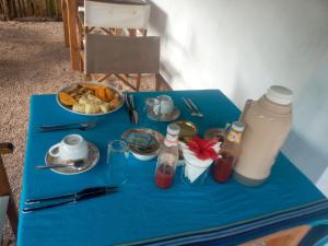 a blue table with food and a bottle of water at Usumba Lodge in Chejuu +31 photos