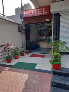 un hotel con macetas delante de una tienda en Hotel Sarika International, en Indore
