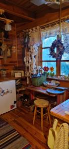 a kitchen with a counter and a table and chairs at Dom wakacyjny in Nadkole