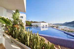 a view of a swimming pool with plants on a balcony at Casa Marc in San José