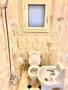 a bathroom with a toilet and a sink at Alexandria Luxury Apartments Stanley Direct Sea View in Alexandria