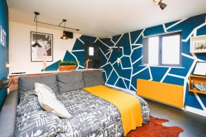 a bedroom with a bed and a colorful wall at Funky City Apartment - Secure Parking - WiFi - Sleeps 6 - No Parties in Belfast