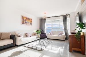 a living room with two couches and a window at LuxuryApt/BestView/PerfectForFamilies/FreeParking in Eilat