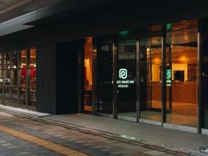 a group of glass doors of a building at Prince Smart Inn Miyazaki in Miyazaki