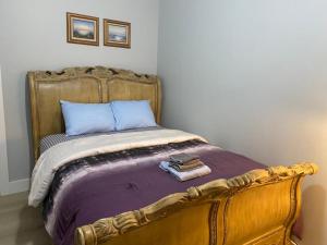 a bedroom with a bed with a wooden frame at Stylish Room 8Mins to Newark Airport in Newark