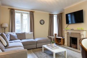 a living room with a couch and a fireplace at Fantastic 2BD apt in THE best location in Dublin in Dublin