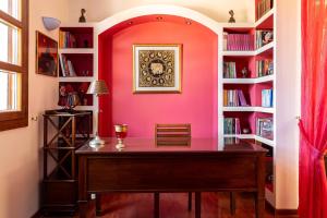 a home office with a desk and bookshelves at Butterfly Garden Villa in Pastida +37 photos