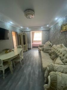 a living room with a couch and a table at Нара in Gyumri