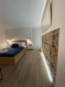 巴勒莫MaRó Loft al Capo的一间带床和石墙的卧室 更多16张照片