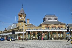 a large building with a clock tower on top of it at City Sophistication with Coastal Vibes in Eastbourne