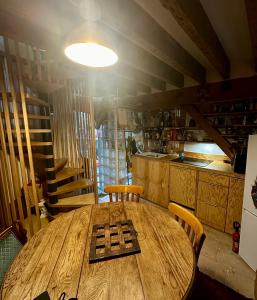 a wooden table in a room with a kitchen at Charmant Duplex calme 40m 2 in Paris