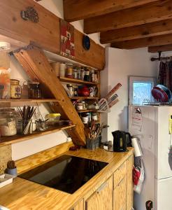 a kitchen with a wooden counter top and a refrigerator at Charmant Duplex calme 40m 2 in Paris