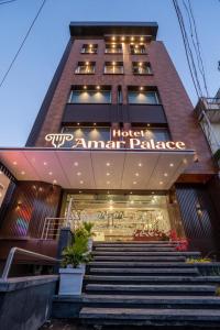 a building with stairs in front of a store at Hotel Amar Palace Ahmednagar in Ahmadnagar