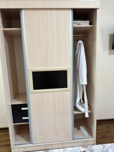 a cupboard with a glass door in a closet at HOTEL ARAL in Nukus