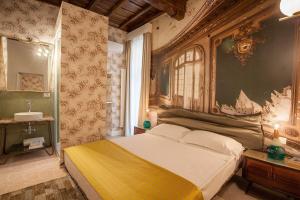 a bedroom with a large bed with a painting on the wall at 59 Steps Trevi in Rome