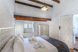 1 dormitorio con 1 cama blanca grande y 2 almohadas en Buenavista 1920 by Ĥ - Centro Ayamonte ABHV400SP, en Ayamonte