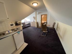 an overhead view of a kitchen with a table and chairs at Hotel Haus Christel in Willingen