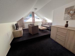 a living room with a couch and a table at Hotel Haus Christel in Willingen