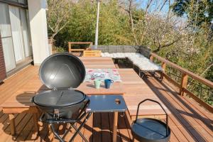 a grill on a wooden table on a deck at Ryokan -Suikoen- by Tranova in Yugawara +91 photos