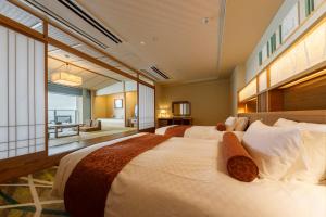 Voodi või voodid majutusasutuse Ryugujo Spa Hotel Mikazuki Fujimitei toas