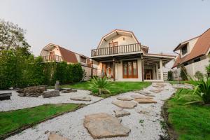 a house with a rock pathway in front of it at 60s Town in Hua Hin