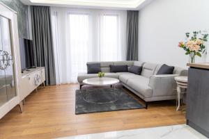 a living room with a couch and a table at A-Dent luxury apartments & Dental Clinic in Gotse Delchev