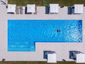 an overhead view of a swimming pool with a person in the water at Zala Springs Golf Resort in Zalacsány