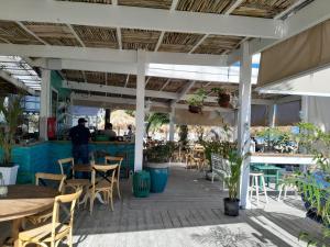 a patio of a restaurant with tables and chairs at Playa Turquesa Ocean Club in Punta Cana