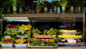 a display case in a store filled with lots of fruits and vegetables at VOLLEY HOTEL ANKARA in Ankara