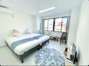 A bed or beds in a room at THE MOON Atami
