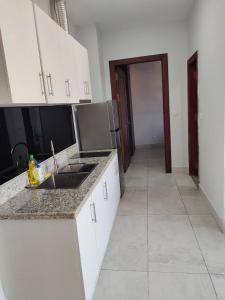 a kitchen with a sink and a counter top at Residence 110 (Hotel and Apartments) in Phnom Penh