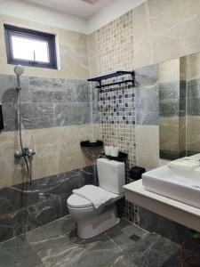 a bathroom with a toilet and a sink at Residence 110 (Hotel and Apartments) in Phnom Penh