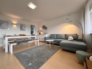 a living room with a couch and a table at Seeblick in Sipplingen in Sipplingen