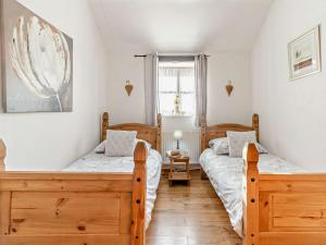 a bedroom with two beds and a window at 3 Bed in Gower 93942 in Ilston