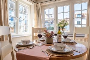 a dining room table with glasses of wine at Sea Haven in Wells next the Sea