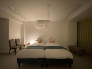 A bed or beds in a room at THE MOON Atami