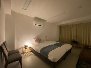 A bed or beds in a room at THE MOON Atami