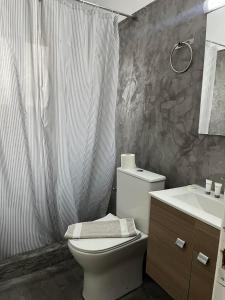 a bathroom with a toilet and a sink and a shower at Utopia Kavos in Kavos