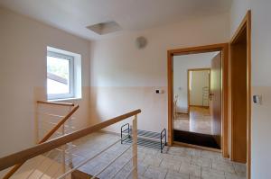 a room with a staircase and a mirror at Apartment Marketa in Pec pod Sněžkou