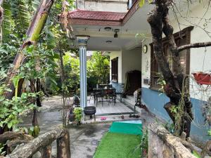 a front porch of a house with a table and chairs at Nepal Bed and Breakfast in Kathmandu