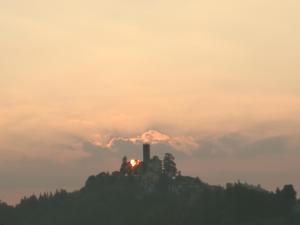 a train on top of a hill in the sunset at casa nel verde Cà dla cola in Mombasiglio