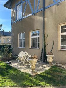 eine Terrasse vor einem Haus mit 2 Stühlen in der Unterkunft Villa Pazelt Top3 in Bad Vöslau