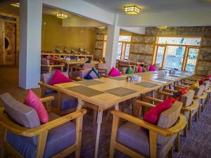 a large dining room with a long table and chairs at Villa Darya - Truly Hunza in Gulmit
