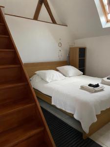 a bedroom with a large bed with wooden shelves at Duplex à la campagne in Vermenton