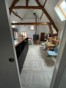 a kitchen and dining room with a ceiling with beams at Duplex à la campagne in Vermenton