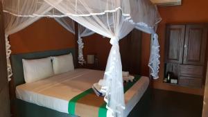 a bedroom with a bed with a canopy at Cabanas by Cloudz Sigiriya in Sigiriya